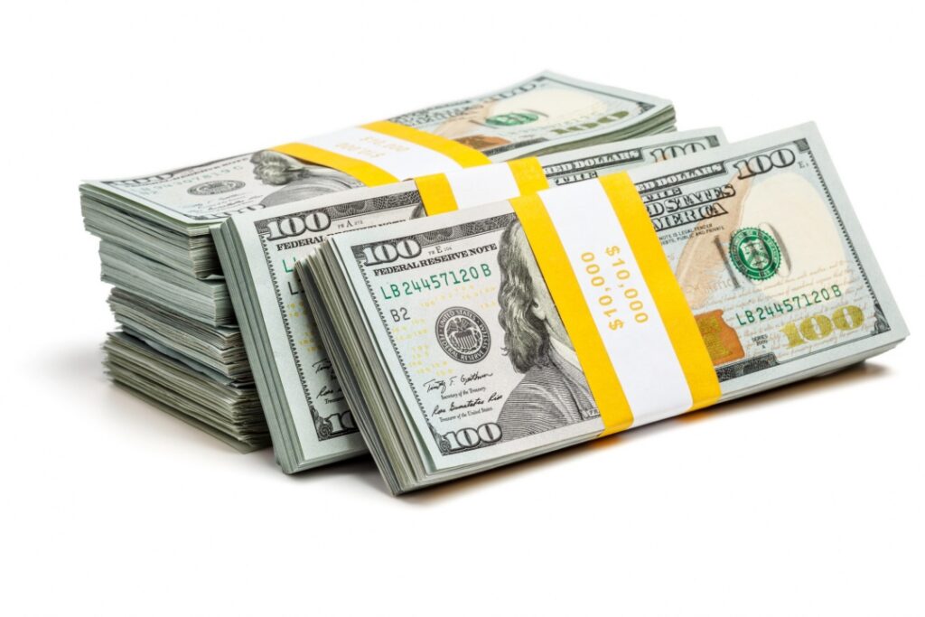 Bundles of 100 US dollars, representing cash investments.